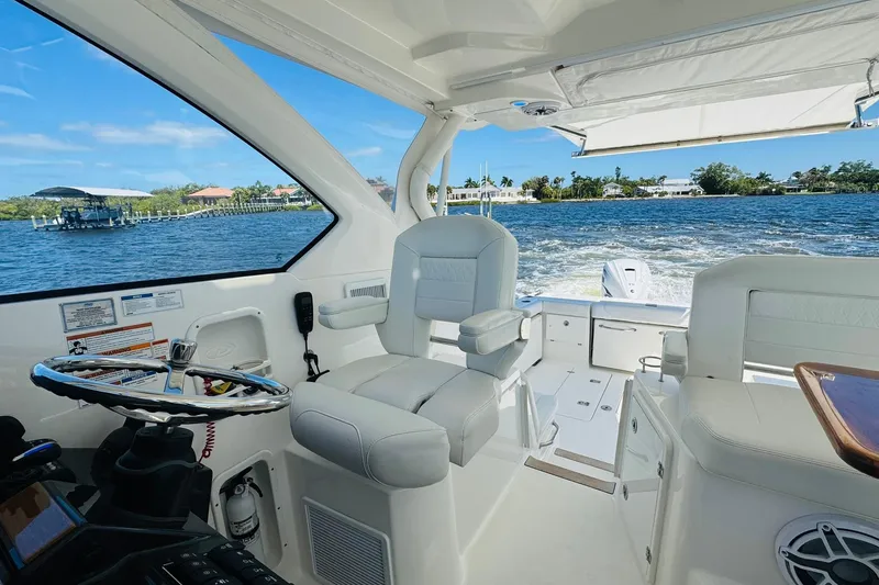 Slide: The Image of Interior view of 2021 Pursuit OS 355 Offshore boat on water. - 32