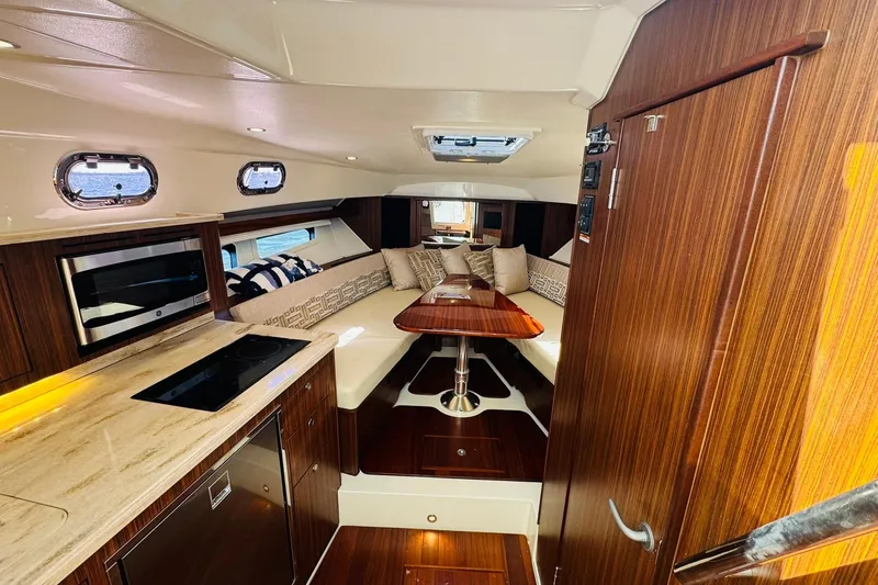Slide: The Image of Interior of 2021 Pursuit OS 355 Offshore yacht with modern kitchen and cozy seating area. - 33