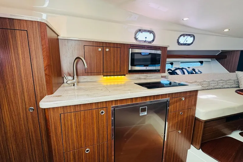 Slide: The Image of Luxurious 2021 Pursuit OS 355 Offshore yacht interior with modern kitchen and seating area. - 36