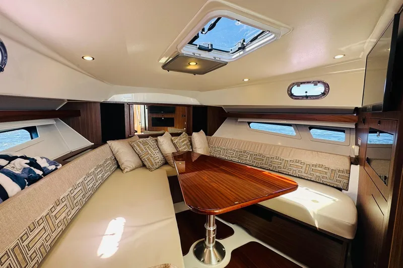 Slide: The Image of Luxurious interior of 2021 Pursuit OS 355 Offshore yacht with elegant seating and wooden table. - 38