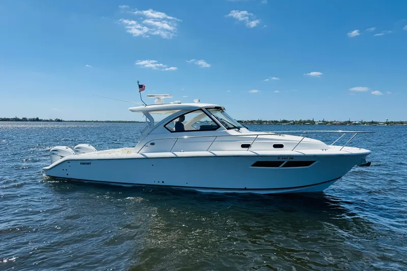 Slide: The Image of 2021 Pursuit OS 355 Offshore boat cruising on a sunny day. - 4