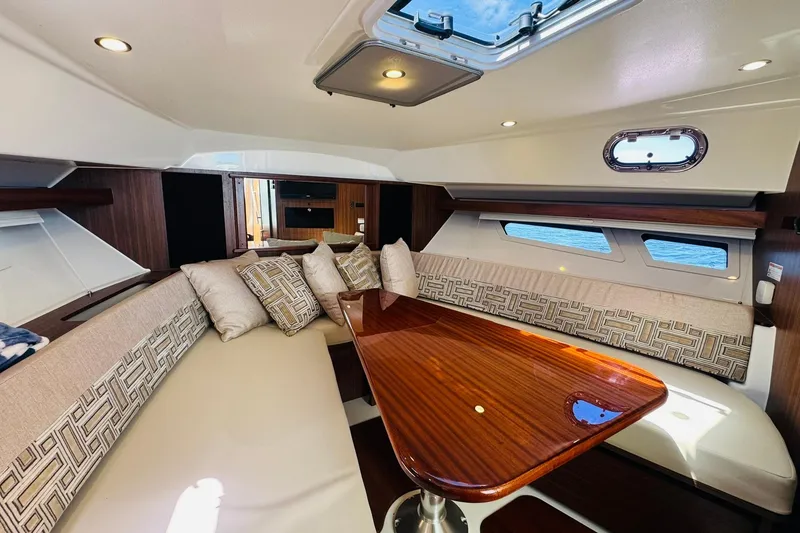 Slide: The Image of Luxurious interior of 2021 Pursuit OS 355 Offshore yacht with elegant seating and wooden table. - 40