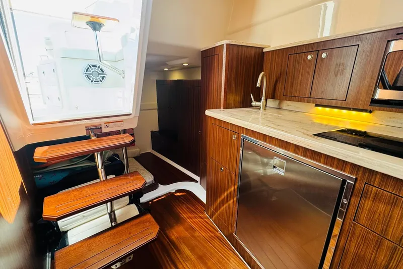 Slide: The Image of Luxurious interior of 2021 Pursuit OS 355 Offshore boat with modern kitchen amenities. - 42