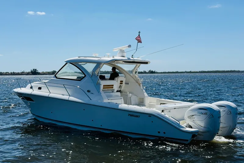 Slide: The Image of 2021 Pursuit OS 355 Offshore boat cruising on open water under clear skies. - 9