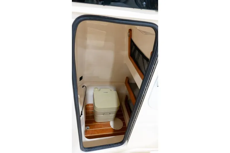 Slide: The Image of 2025 Grady-White Fisherman 257 boat interior with compact toilet and storage. - 10