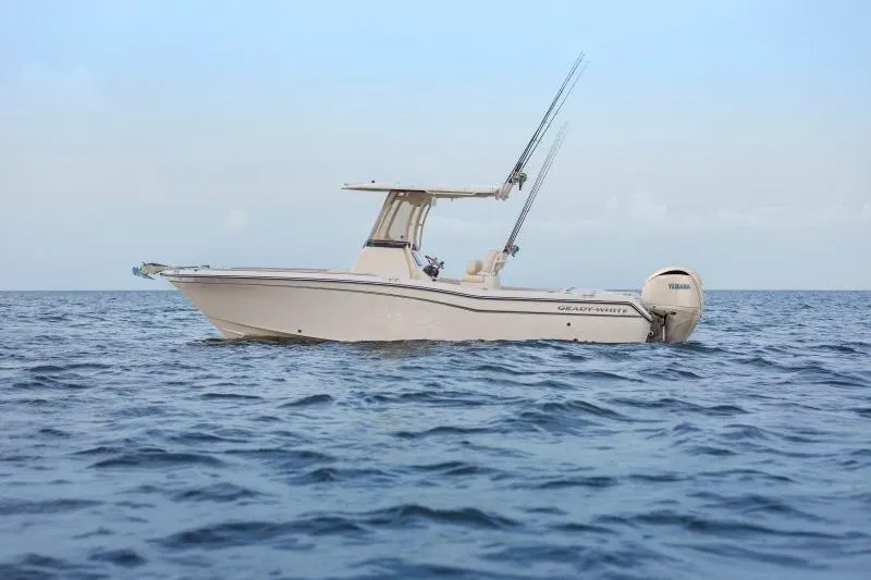 Slide: The Image of 2025 Grady-White Fisherman 257 boat on open sea, equipped with fishing rods. - 2