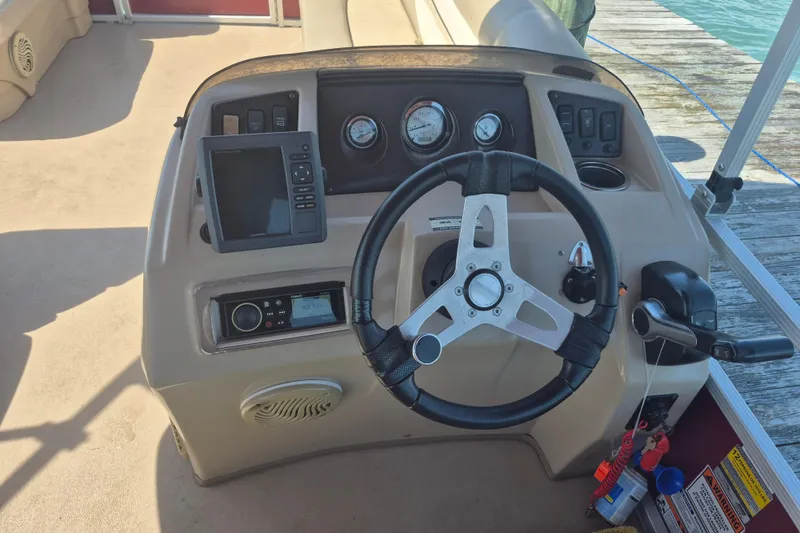 Slide: The Image of Steering console of a 2012 Bennington 22 SSI boat with gauges and controls. - 11