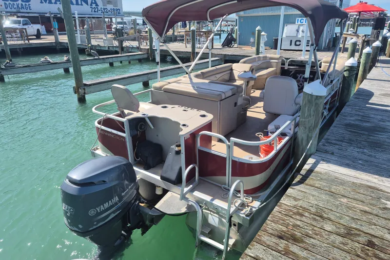 Slide: The Image of 2012 Bennington 22 SSI pontoon boat docked with Yamaha outboard motor. - 14