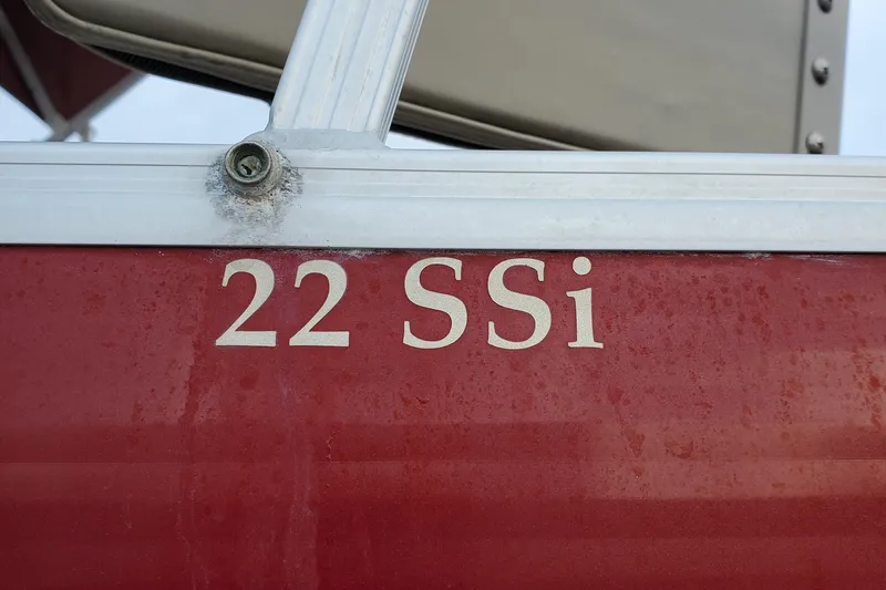 Slide: The Image of Red Bennington 22 SSI boat, model year 2012, with visible lettering. - 3