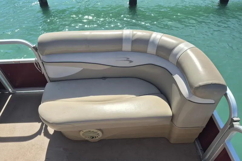 Slide: The Image of Beige seating on 2012 Bennington 22 SSI pontoon boat, with water in the background. - 7