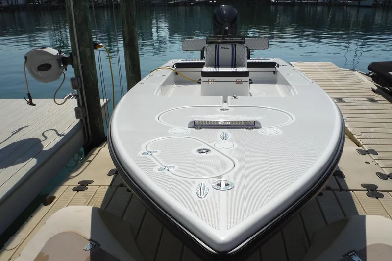 The Image of 2023 Lake & Bay 21 Boca Grande boat docked at marina, showcasing sleek design and modern features. - 0