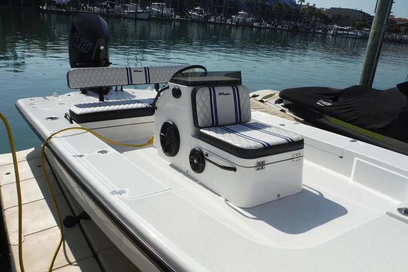 Slide: The Image of 2023 Lake & Bay 21 Boca Grande boat docked, featuring sleek seating and powerful engine. - 3