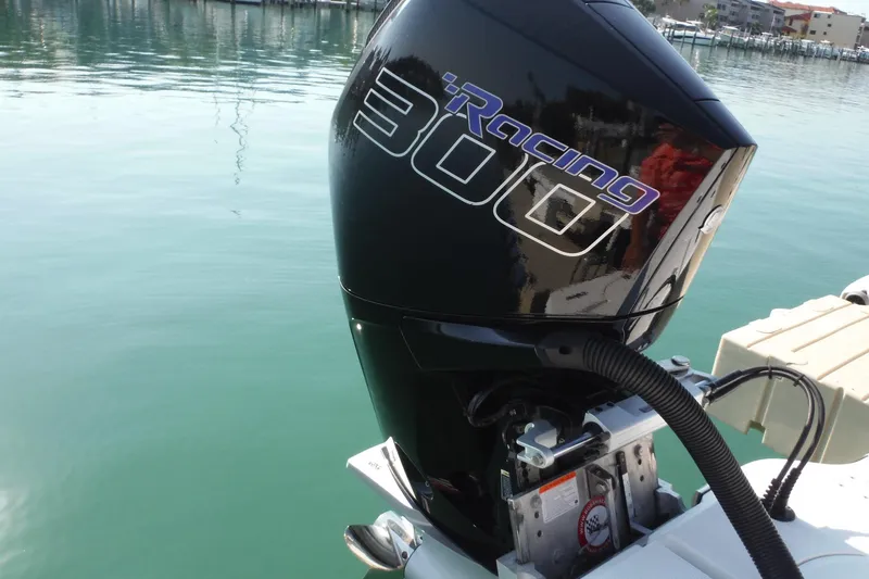 Slide: The Image of Outboard motor on 2023 Lake & Bay 21 Boca Grande boat by the water. - 6
