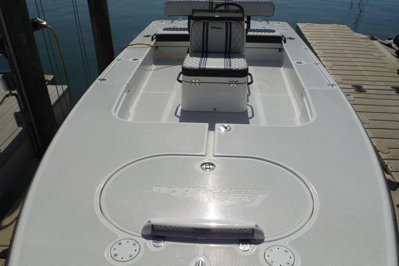 Slide: The Image of 2023 Lake & Bay 21 Boca Grande boat docked, showcasing sleek design and spacious deck. - 7