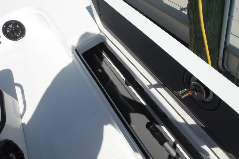Slide: The Image of Storage compartment on 2023 Lake & Bay 21 Boca Grande boat, containing ropes and safety equipment. - 18