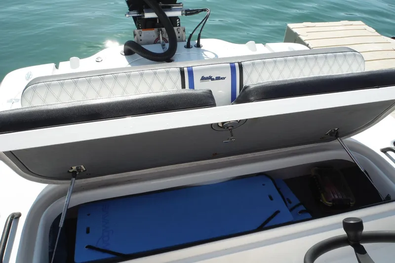 Slide: The Image of 2023 Lake & Bay 21 Boca Grande boat interior with storage compartment and speaker. - 19