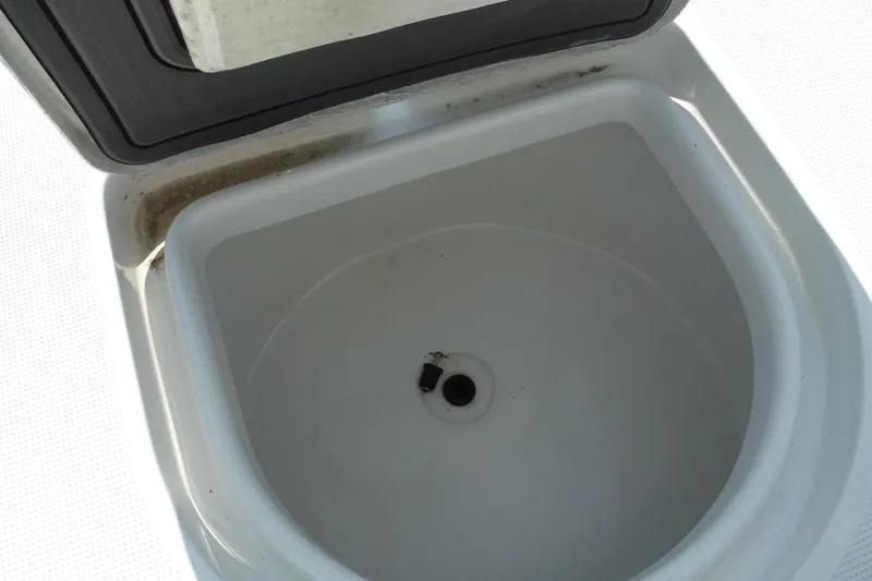 Slide: The Image of 2023 Lake & Bay 21 Boca Grande boat storage compartment open by the dock. - 20