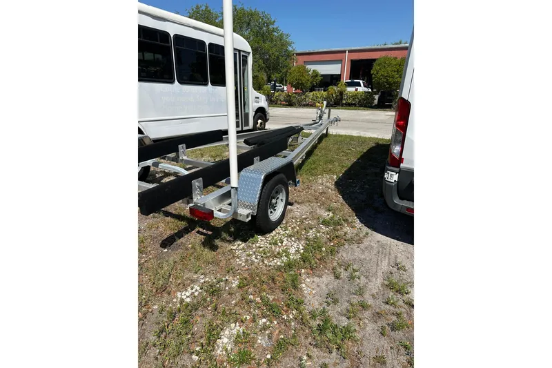 Slide: The Image of Trailer for 2023 Lake & Bay 21 Boca Grande boat parked outdoors. - 23