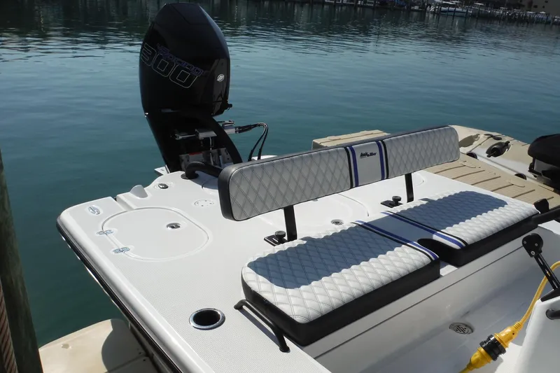 Slide: The Image of 2023 Lake & Bay 21 Boca Grande boat with cushioned seating and powerful outboard motor. - 4