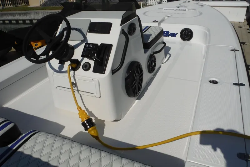 Slide: The Image of 2023 Lake & Bay 21 Boca Grande boat interior with steering console and yellow power cord. - 5