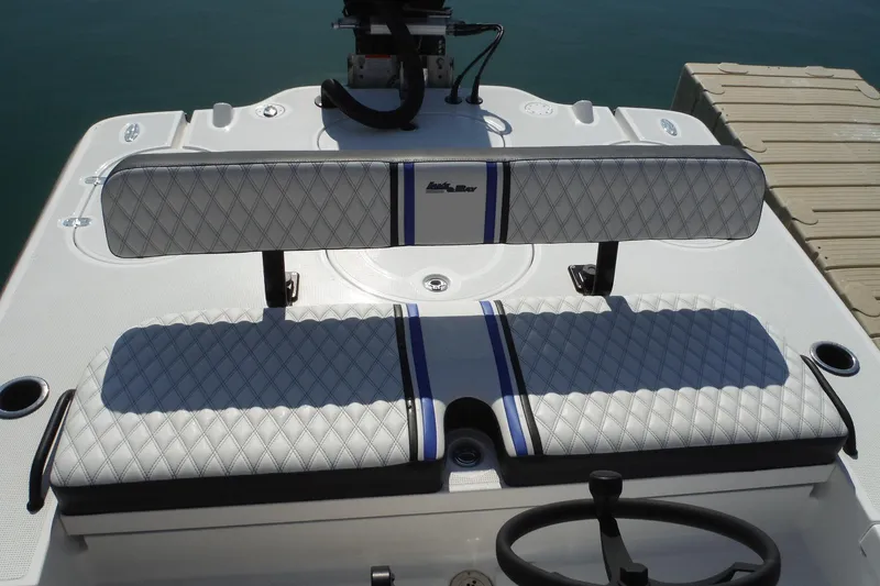 Slide: The Image of 2023 Lake & Bay 21 Boca Grande boat interior with diamond-stitched seating near dock. - 9