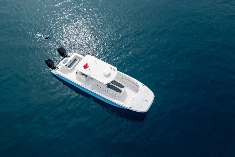 Slide: The Image of 2024 Invincible 33 Catamaran cruising on open blue water. - 10