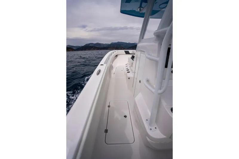 Slide: The Image of 2024 Invincible 33 Catamaran on open water, showcasing sleek deck design and ocean backdrop. - 19