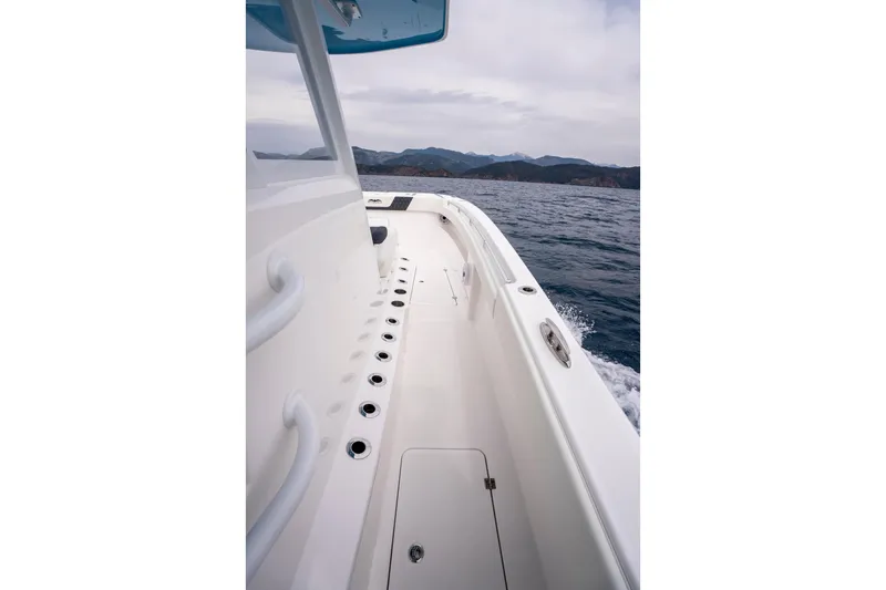 Slide: The Image of 2024 Invincible 33 Catamaran cruising on open water, showcasing sleek deck design. - 20