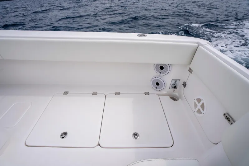 Slide: The Image of 2024 Invincible 33 Catamaran deck with storage hatches and ocean view. - 28
