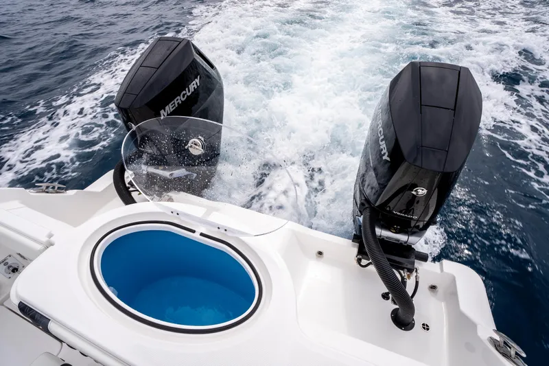 Slide: The Image of 2024 Invincible 33 Catamaran with dual Mercury engines cruising on open water. - 29