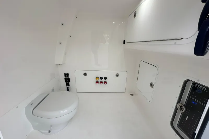 Slide: The Image of 2024 Invincible 33 Catamaran interior with toilet and control panel. - 30