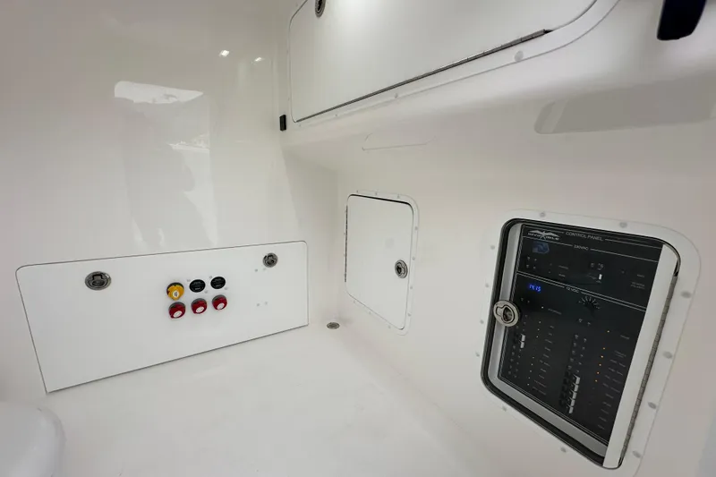 Slide: The Image of 2024 Invincible 33 Catamaran interior with control panel and storage compartments. - 31