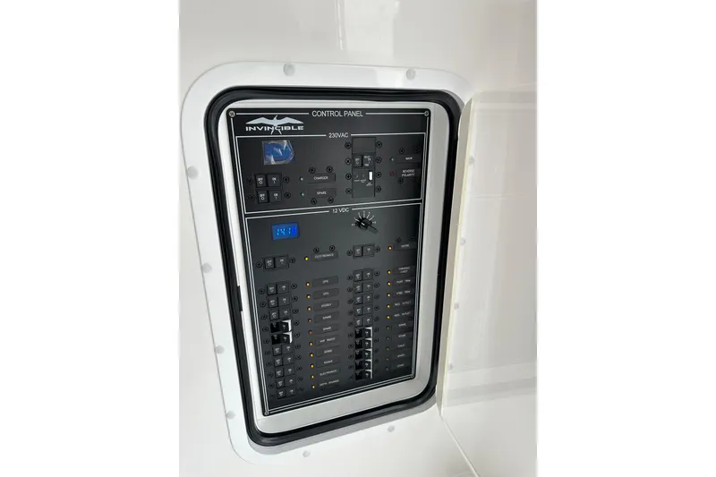 Slide: The Image of Control panel of 2024 Invincible 33 Catamaran, featuring 230VAC and 12VDC systems. - 32