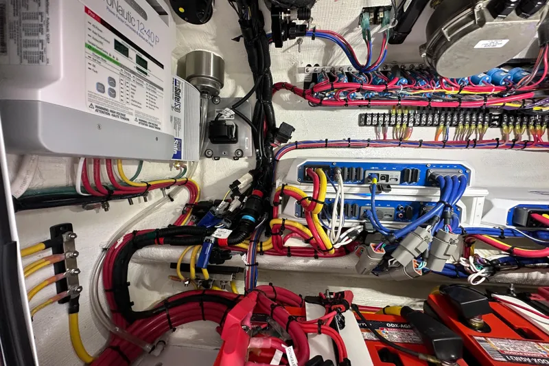 Slide: The Image of Electrical wiring system inside 2024 Invincible 33 Catamaran, showcasing organized cables and components. - 33