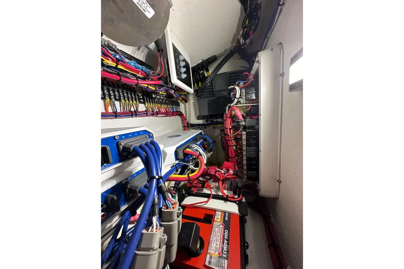 Slide: The Image of Electrical wiring and components inside a 2024 Invincible 33 Catamaran boat. - 34
