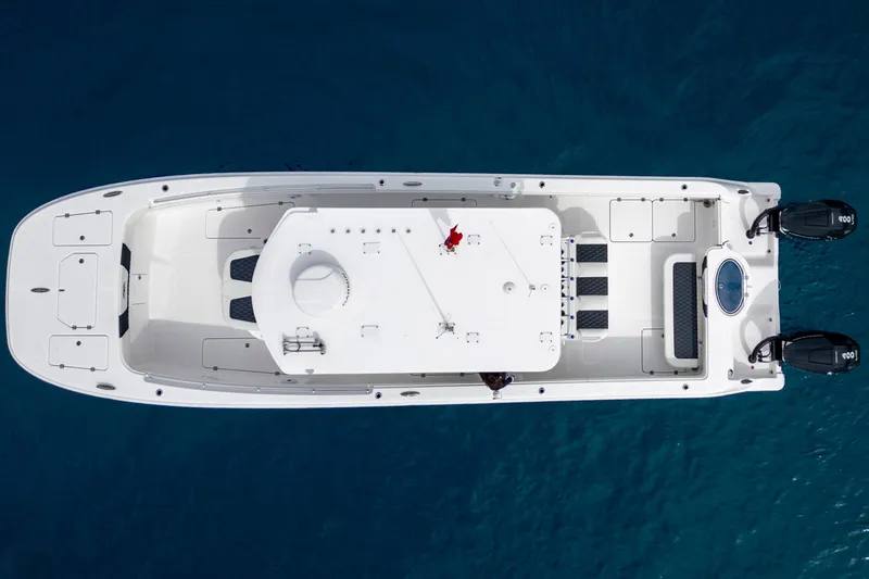 Slide: The Image of Overhead view of 2024 Invincible 33 Catamaran on clear blue water. - 8