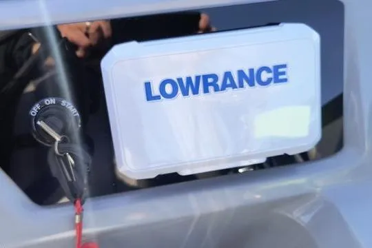 Slide: The Image of Lowrance device on 2026 Viaggio Lago V22U dashboard with ignition key. - 7