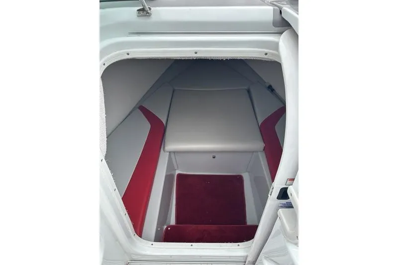 Slide: The Image of Interior cabin of a 2006 Custom 245 Boss boat with red and gray seating. - 19