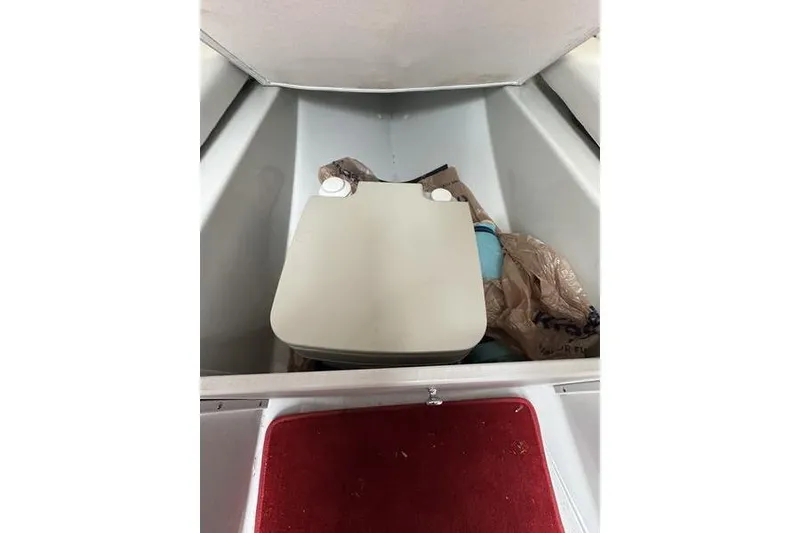 Slide: The Image of Boat interior storage compartment with portable toilet, Custom 245 Boss, 2006 model. - 20