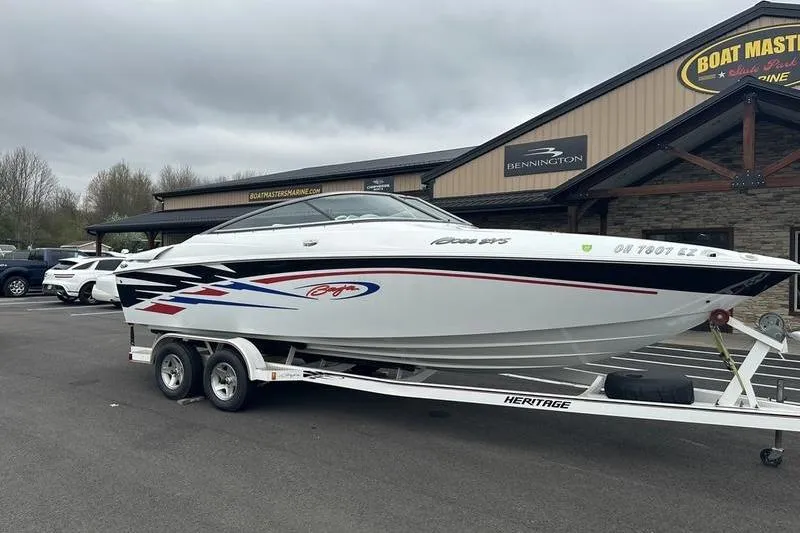 Slide: The Image of Custom 2006 245 Boss boat on trailer at dealership, featuring sleek design and vibrant graphics. - 22