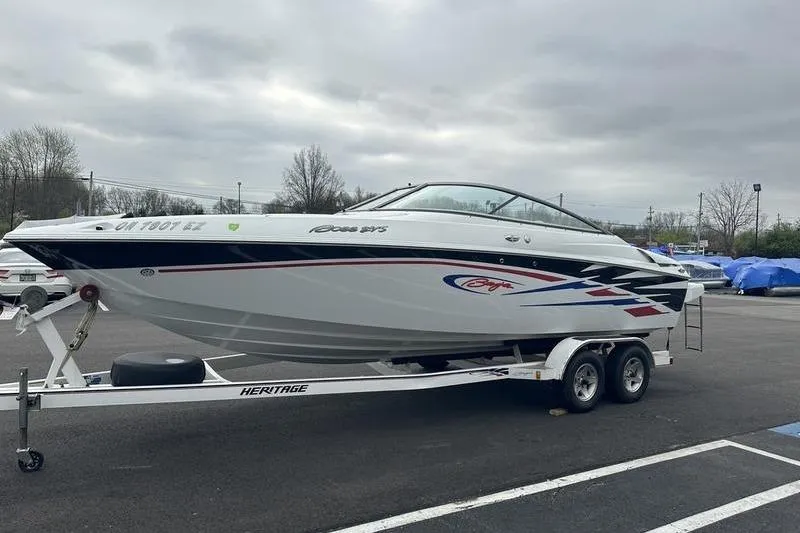 Slide: The Image of Custom 2006 245 Boss boat on trailer in parking lot, overcast sky. - 24