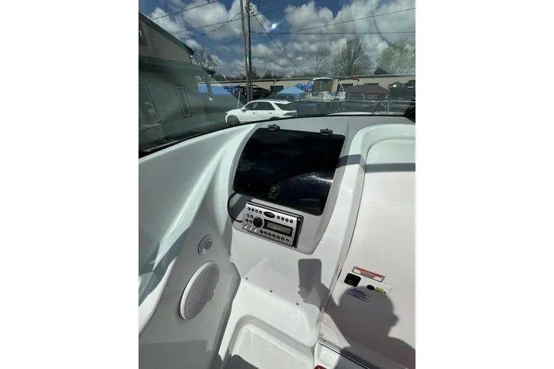 Slide: The Image of Interior dashboard of a 2006 Custom 245 Boss boat with control panel. - 27