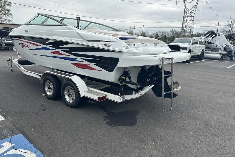 Slide: The Image of Custom 245 Boss 2006 boat on trailer, featuring sleek design and vibrant graphics. - 6