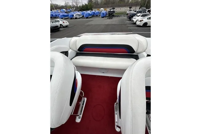 Slide: The Image of Interior of a 2006 Custom 245 Boss boat with white and red seating. - 7