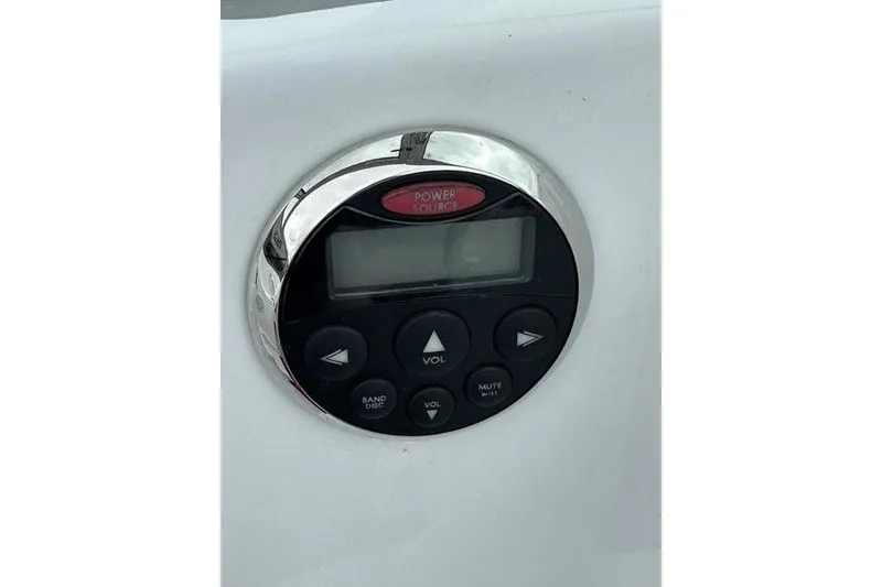Slide: The Image of Round control panel with buttons and display on a Custom 245 Boss, 2006 model. - 8