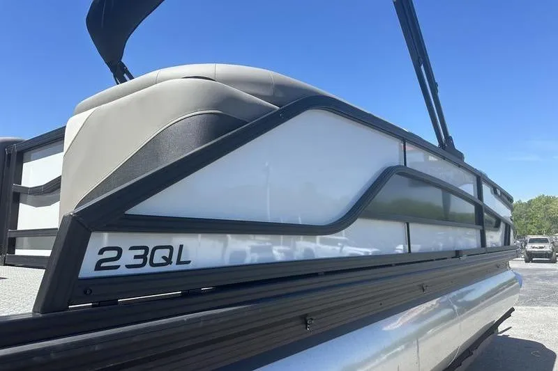 Slide: The Image of 2026 Evotti 523QL pontoon boat side view under clear blue sky. - 14