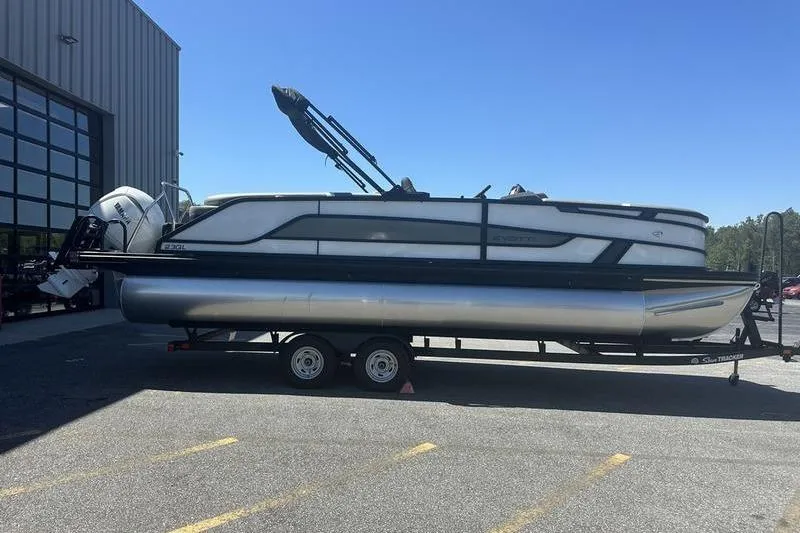 Slide: The Image of 2026 Evotti 523QL pontoon boat on trailer outside a large building. - 4