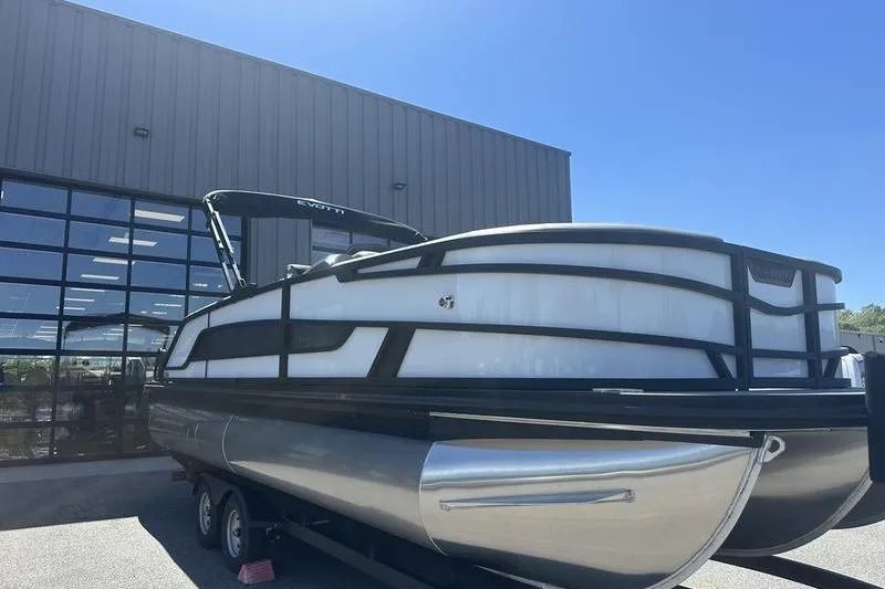 Slide: The Image of 2026 Evotti 523QL pontoon boat on trailer, parked outside a modern building. - 5