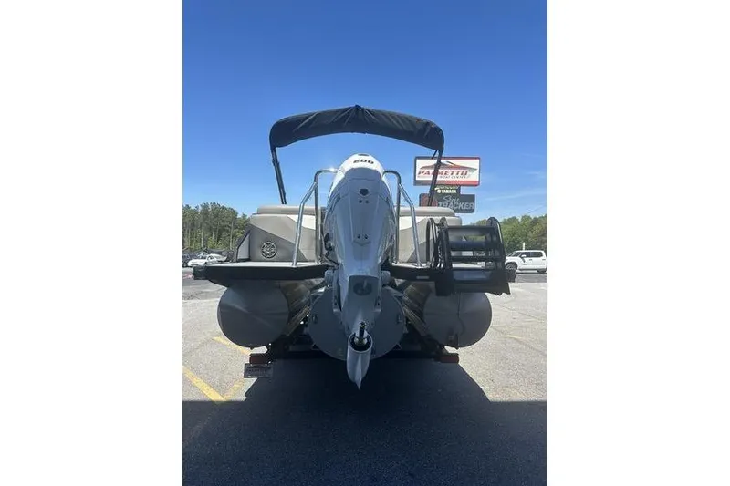Slide: The Image of 2026 Evotti 523QL boat with outboard motor, parked outdoors under clear blue sky. - 6