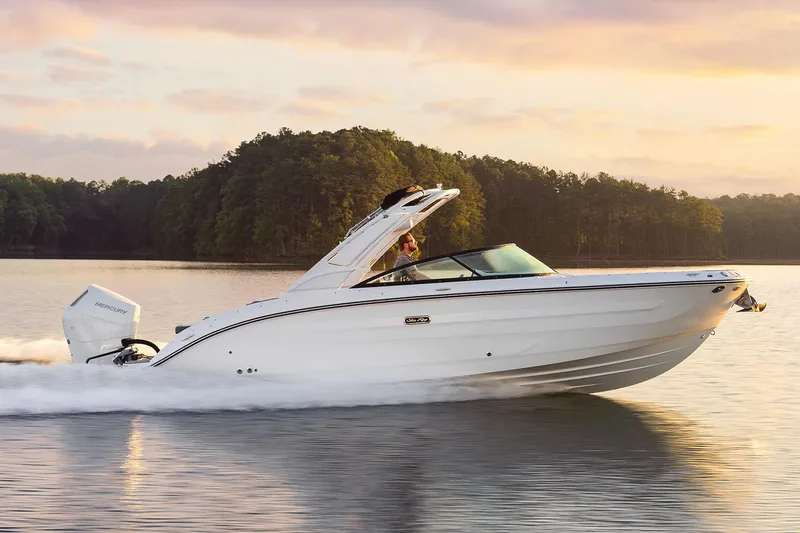 The Image of 2026 Sea Ray SDX 270 Outboard boat displayed outside a large storage facility. - 0